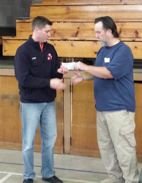 President Jeff Hungerford presenting a representitave from the Illinois Fire Safety Alliance with a check in the amount of $1200 for Camp I Am Me.